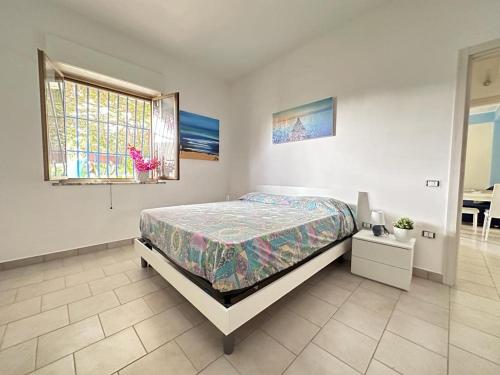 a bedroom with a bed and a window at Villa Eleonora in Palmi