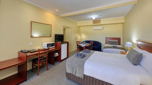 Ένα ή περισσότερα κρεβάτια σε δωμάτιο στο Oasis Motor Inn