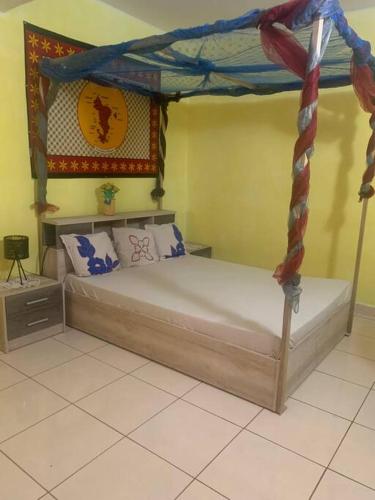 a bedroom with a bed with a canopy at Maison T3 75m2 in Ouangani