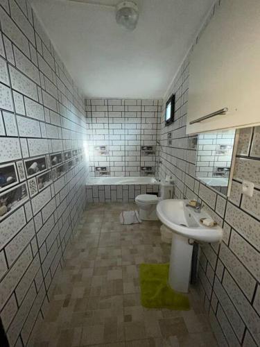 a bathroom with a sink and a toilet at Maison T3 75m2 in Ouangani