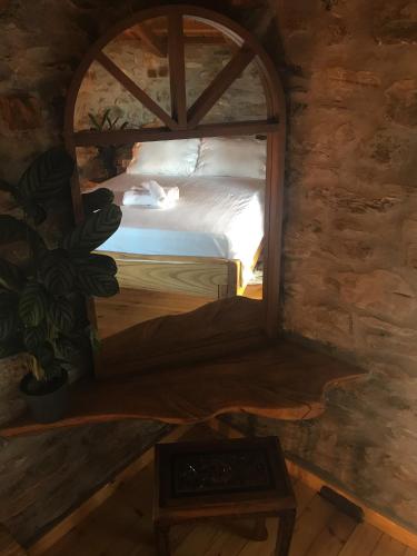 a bedroom with a bed in a room with a window at Aristoteli's Stone House in Makrirrákhi