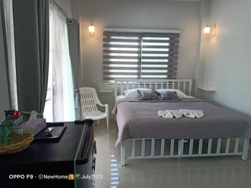 um quarto com uma cama e uma janela em Min House em Lamphun