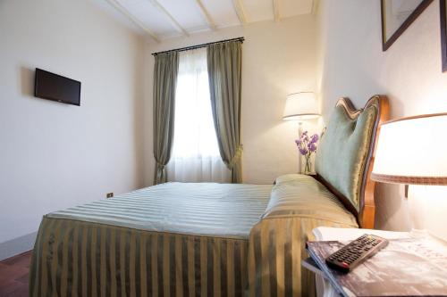 a hotel room with a bed and a window at Agriturismo San Galgano in Chiusdino
