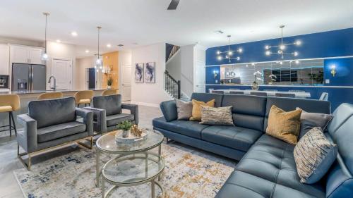 a living room with blue furniture and a kitchen at 1249 Challenge in Davenport