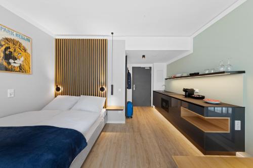 a bedroom with a king sized bed and a desk at Nena Apartments Berlin Adlershof in Berlin