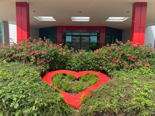 a heart in a field of flowers in a building at ibis Styles Milano Est Settala in Settala