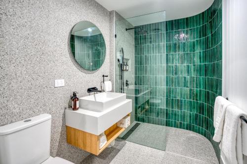 a bathroom with a sink and a glass shower at Essence Peregian Beach in Peregian Beach