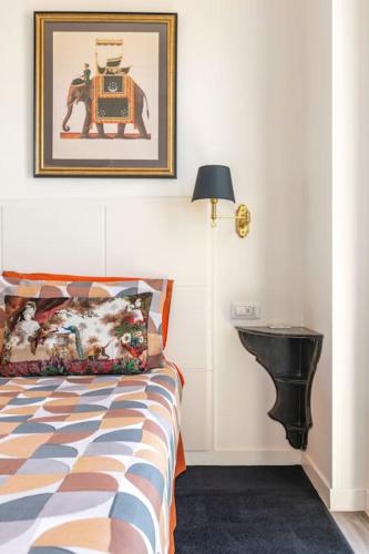 a bedroom with a bed and a picture on the wall at Eleventh Floor Suites in Cagliari