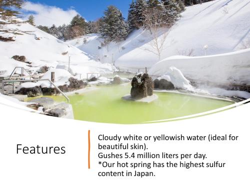 a picture of a pool of water in the snow at Manza Kogen Hotel in Tsumagoi