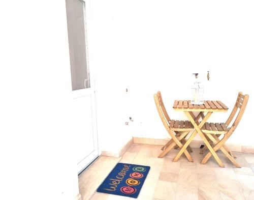 a dining room with a table and two chairs and a rug at LC COUNTRY in Pisa
