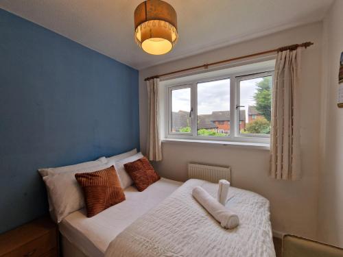 a small bedroom with a bed with a window at Nice Living Serviced Accommodations 7 in Rugby