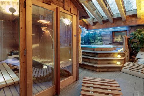 a screened in porch of a house with a hot tub at Francois Boutique Rooms - Matterhorn Retreat & SPA in Cervinia in Breuil-Cervinia