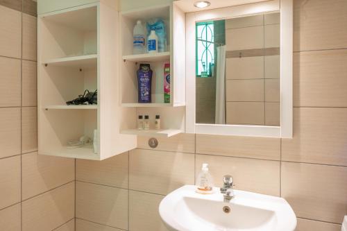 a bathroom with a sink and a mirror at Stunning Views Kantouni Beach in Kalymnos