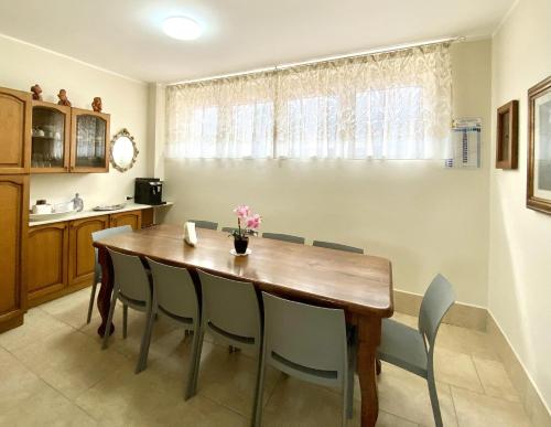 a dining room with a wooden table and chairs at Albergo Lodrino in Villa