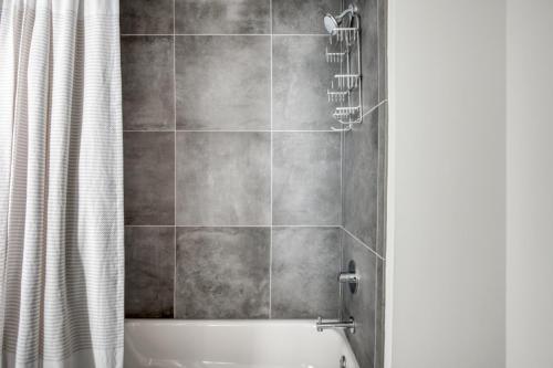 a bathroom with a shower with a bath tub at South Loop 1BR w gym pool nr Grant Park CHI-764 in Chicago