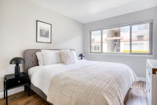 a white bedroom with a bed and a window at Mountain View 2BR w Pool Gym BBQ nr Target SFO-623 in Mountain View