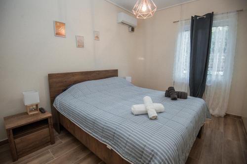 a bedroom with a bed with two towels on it at Sea Zen Guesthouse in Rafina