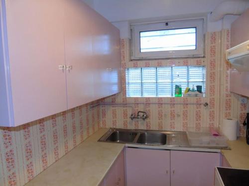 a kitchen with a sink and a window at VOULIAGMENI RIVIERA center between Beach and Lake in Athens