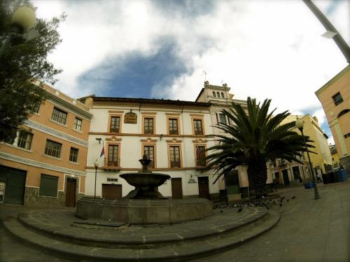 a building with a fountain in front of a building at Mía Leticia B&B in Quito