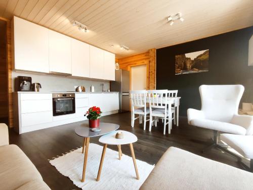 a living room with a couch and a table at Gøtugjógv Log House in Gøtugjógv