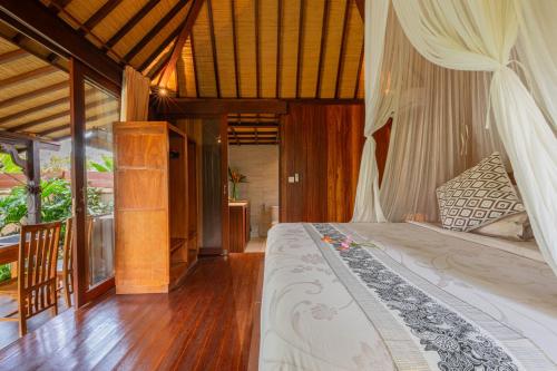 a bedroom with a large bed in a room at NILUH Private Villas Ubud in Ubud