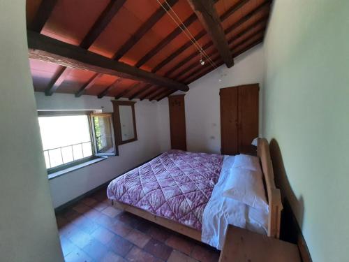 a bedroom with a bed and a window at Agriturismo Cà Nova in Palazzuolo sul Senio