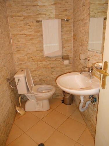 a bathroom with a toilet and a sink at Hostel Del Mar in Varna City
