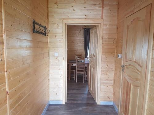a hallway in a wooden house with a dining room at Wooden Holiday Home in Skrzynia with Terrace in Osiek