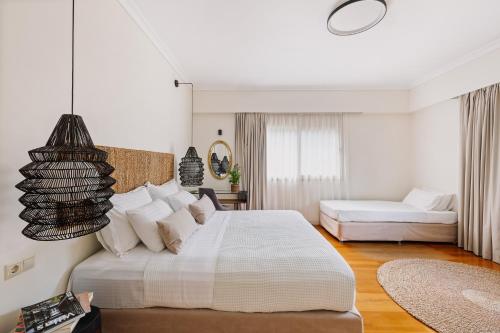 a white bedroom with a large bed and a couch at Bello Blu Luxury Villa in Asgourou