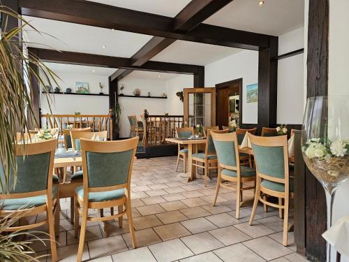 a dining room with wooden tables and chairs at GreenLine Ferienhotel Forelle in Thale