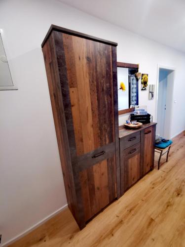 a large wooden cabinet in the corner of a room at Zentrumsnahe Privatunterkunft Freistadt in Freistadt