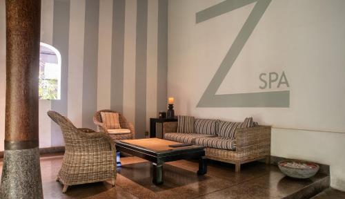 a living room with a couch and two chairs at Wallawwa in Katunayake