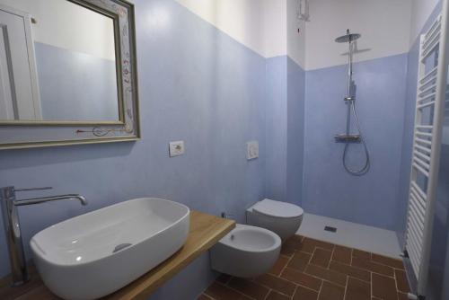 a bathroom with a sink and a toilet and a mirror at Talacchio in Città di Castello