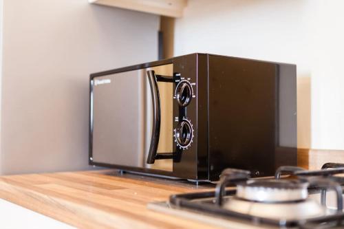 a microwave oven sitting on top of a counter at Fusilier apartment wrexham city in Wrexham