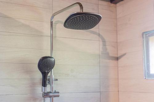 a shower with a shower head in a bathroom at NILUH Private Villas Ubud in Ubud