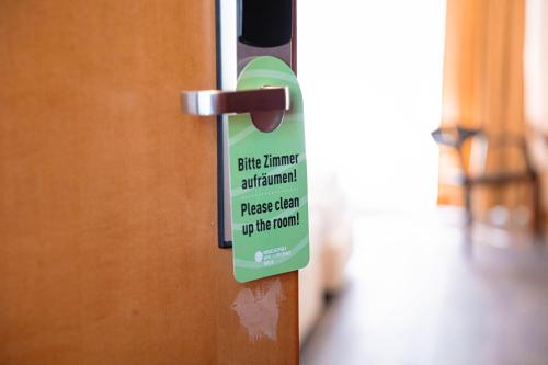 a sign on a door that says please open up the door at Müggelseeperle in Berlin