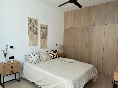 a bedroom with a bed and a ceiling fan at VILLA MARIAH Barrosa Playa in Novo Sancti Petri