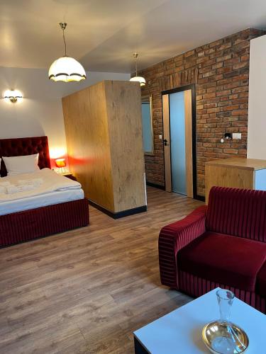 a hotel room with a bed and a couch at Apartamenty pod Katedrą in Bielsko-Biała