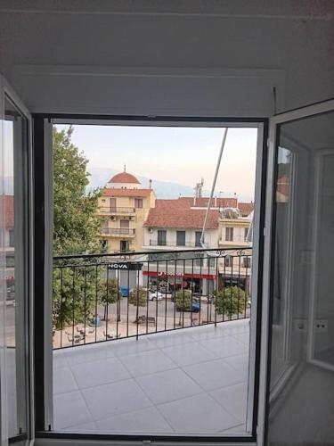 a view from an open window of a balcony at natasas luxury apartment in Nafpaktos