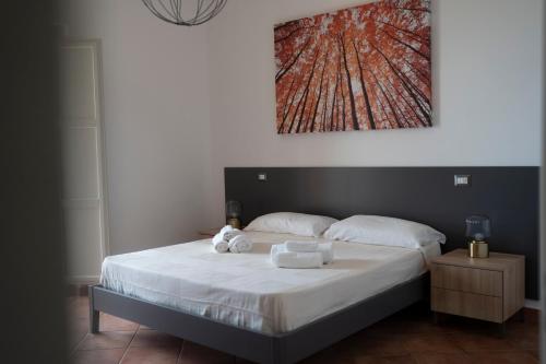 a bedroom with a bed with two towels on it at Villa Angeline in Guarazzano