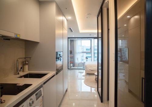 a kitchen with a sink and a counter top at UH FLAT The Seocho in Seoul