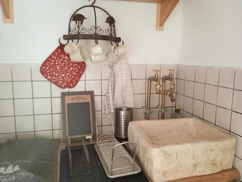 a kitchen with a sink and a chopping board and a light at Gasphouse in Castellana Grotte