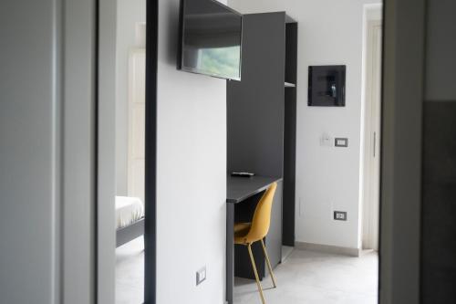 a mirror in a room with a desk and a chair at Villa Angeline in Guarazzano