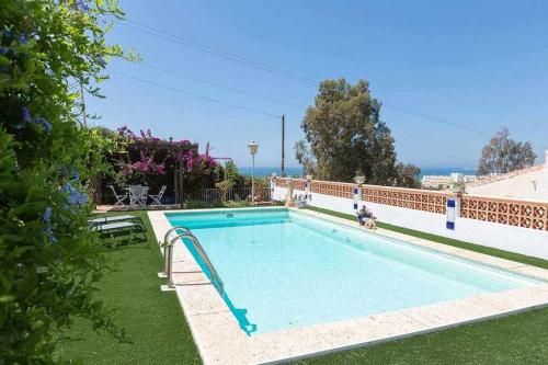 a swimming pool in the yard of a house at Caleta del Sol con piscina terraza y playa in Caleta De Velez