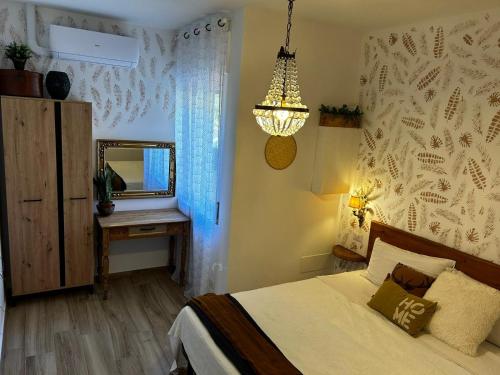 a bedroom with a bed and a mirror and a lamp at TROPICAL HOME PORTO CERESIO in Porto Ceresio