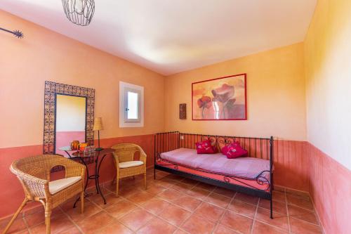 a bedroom with a bed and a table and chairs at La Ferme du petit Ségriès Bed and Breakfast in Moustiers-Sainte-Marie