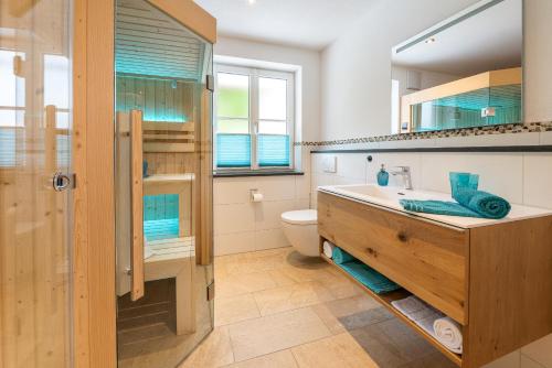 a bathroom with a sink and a toilet at Ferienwohnungen Zober am Mühlbach in Oberammergau