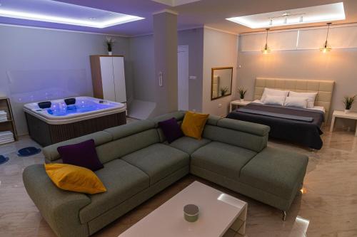 a living room with a couch and a bed at Level 2 Spa Apartman in Šabac