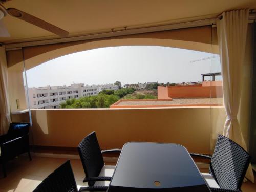 a room with a table and chairs and a large window at EDA Paradise Vera Playa in Vera