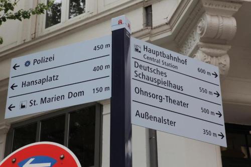 a street sign with many street signs in front of a building at Hamburg Room in Hamburg